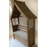 GAZEBO, weathered treated slatted timber and trellis construction with gable roof and rising seat,