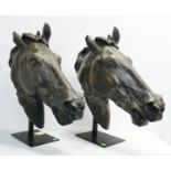 ANDREW MARTIN HORSE HEADS, a pair, 76cm H on metal stands. (2)