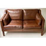 DANISH SOFA, two seater grained mid brown leather with teak supports, 138cm W.