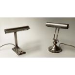 DESK LAMPS, two early 20th century silvered both with hooded shades, 33cm H and 29cm H respectively.