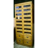 HABERDASHERY CABINET, oak, 88cm x 54cm x 198cm with sixteen glazed drawers and four further