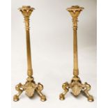 CANDLESTICKS, a pair, Egyptian style gilt metal leaf crest, reeded column and triform supports, 36cm