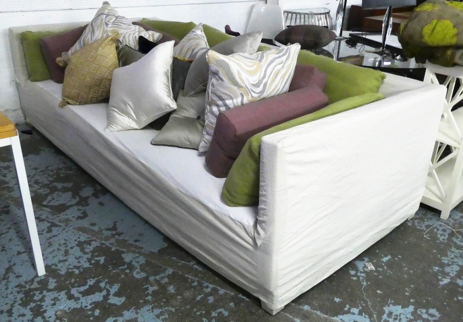 CHRISTIAN LIAIGRE SOFA, 276cm W with various slatter cushions, loose covers. (with faults)