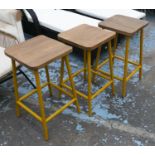 BAR STOOLS, a set of three, 66cm H, vintage style, machinists design, yellow metal supports. (3)