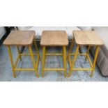 BAR STOOLS, a set of three, 66cm H, vintage style, machinists design, yellow metal supports. (3)