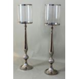 FLOOR STANDING CANDLE LANTERNS, a pair, 160cm H, polished metal and glass. (2)