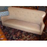 SOFA, 190cm L x 99cm H 1960's style, with a buttoned back on short wooden turned supports.