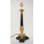 LAMP, French Empire style, bronze column with gilt Corinthian top and triform paw feet base, 47cm H.
