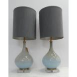 COACH HOUSE TABLE LAMPS, a pair, 68cm H blue glass with shades. (2)