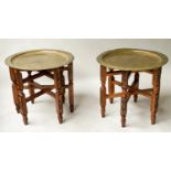 OCCASIONAL TABLES, a pair, early 20th century with Benares type brass incised tray tops and carved
