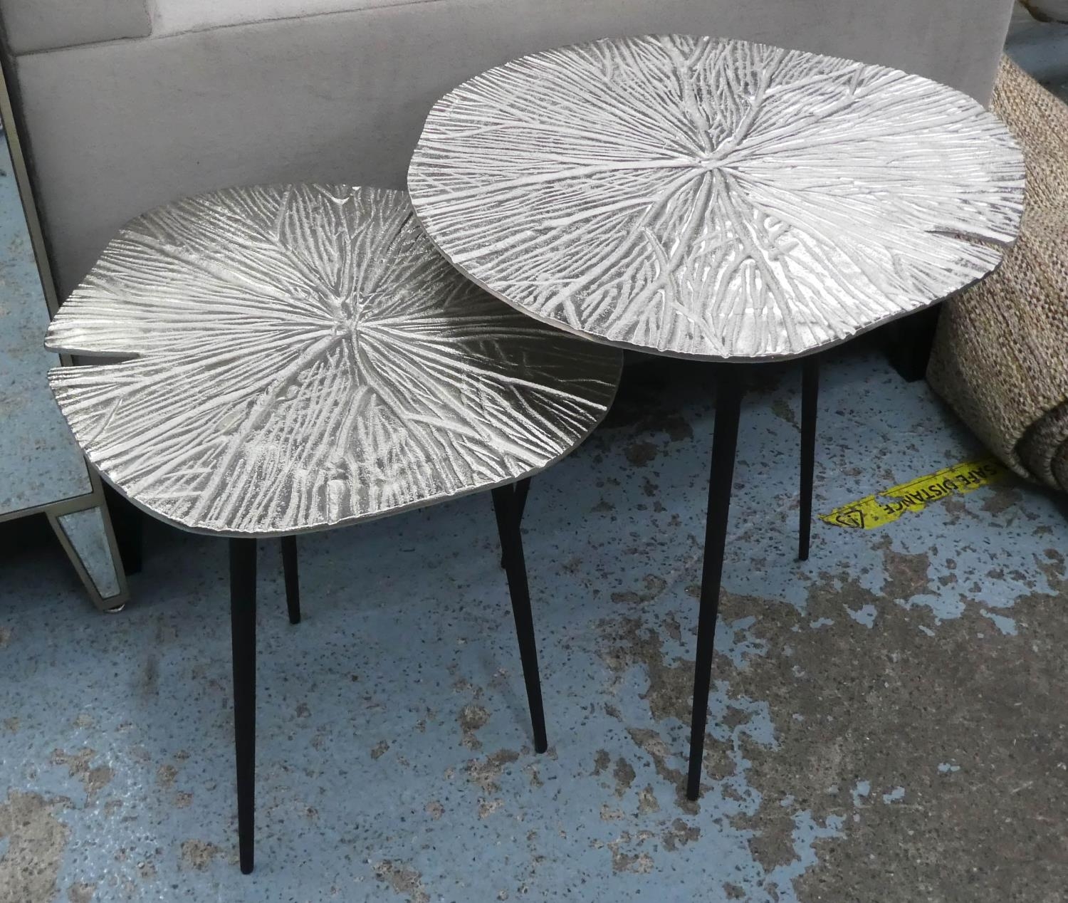 LILY PAD SIDE TABLES, a pair, graduated pair, 49cm x 53cm x 54cm at largest, polished metal tops. (