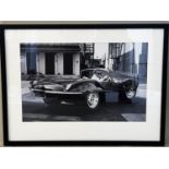 AFTER JOHN DOMINIS 'Steve McQueen in his Jaguar', 63cm x 83cm, framed and glazed.