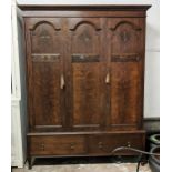 WARDROBE, 203cm H x 158cm x 51cm circa 1920, oak with three doors enclosing brass hanging rails