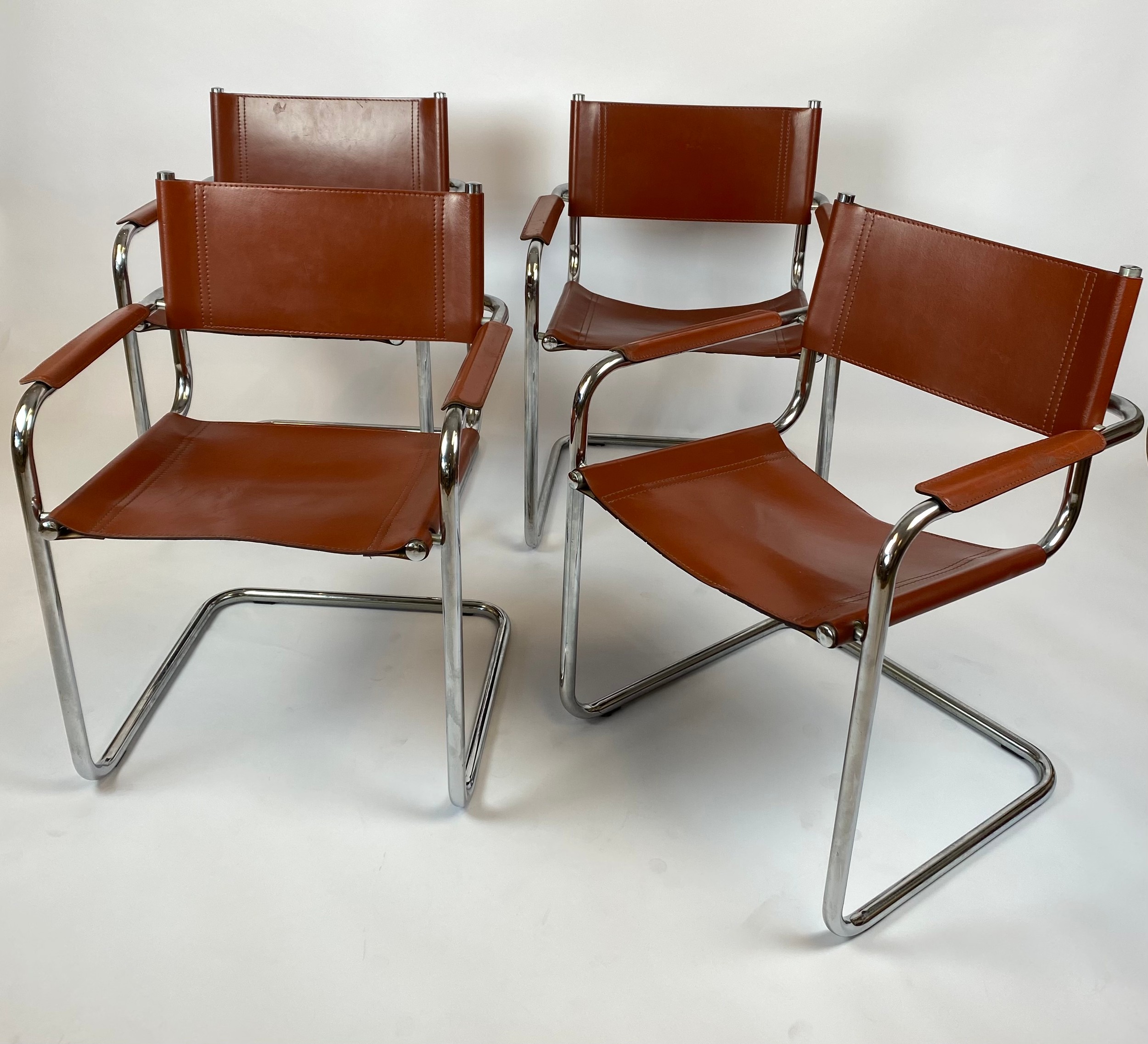 DINING ARMCHAIRS, a set of four, tan leather and cantilever chrome framed, after a design by Mart