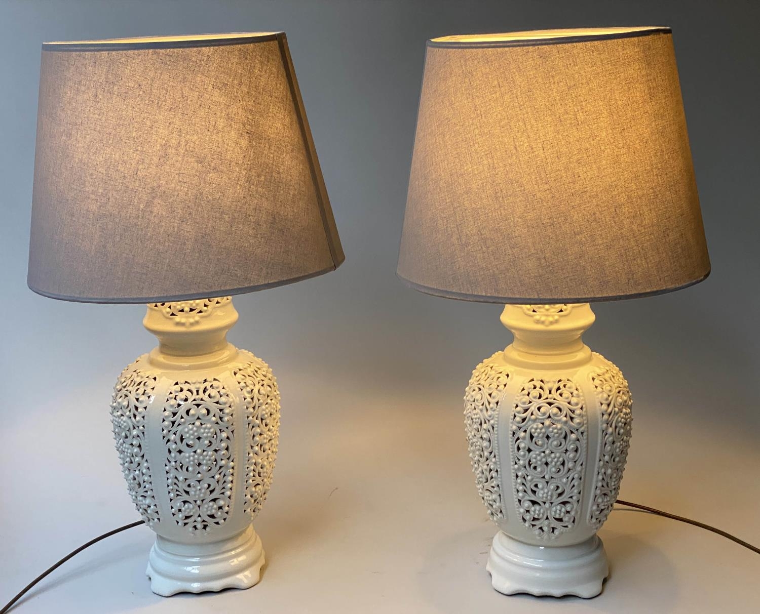 TABLE LAMPS, a pair, reticulated white ceramic of vase form with shades, 76cm H. (2)