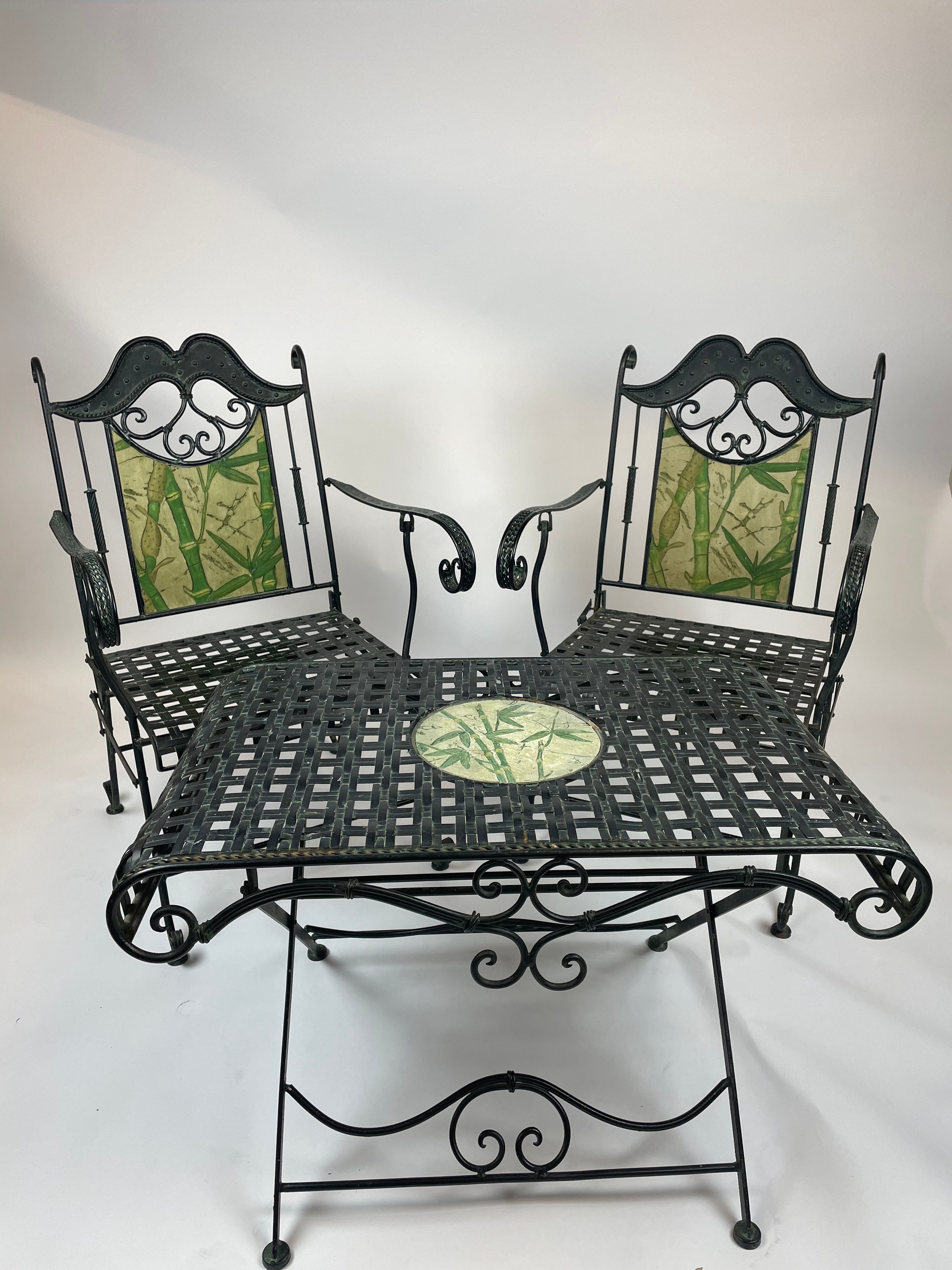 CONSERVATORY CHAIRS AND TABLE, wrought iron inlaid, with faux marble painted bamboo print, 57cm W