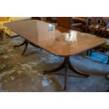 DINING TABLE, Regency design figured mahogany extending with three extra leaves on outswept