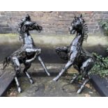 CONTEMPORARY SCHOOL, rearing stallions, a pair, 127cm H. (2)