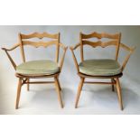 ERCOL ARMCHAIRS, a pair, solid elm jointed with bar back and solid seats 'stamped'. (2)