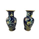 VASES, a pair, Art Nouveau Majolica, with foliate decoration on dark blue glazed ground. 55cm H. (2)