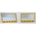 HALL MIRRORS, a pair, each with five coat hooks, gilt metal frames, 41cm x 66cm x 5cm. (2)