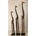 FAMILY OF THREE GIRAFFES, carved wood, 200cm at tallest. (3)