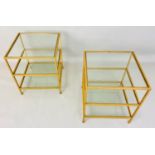 MAISON BAGUES STYLE SIDE TABLES, a pair, gilt metal and glass, three tiers each 51cm x 45cm x