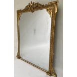OVERMANTEL MIRROR, 19th century giltwood and gesso moulded with urn crest and scroll supports, 135cm