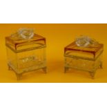 JEWELLERY BOXES, two, French cut crystal, amber glass, lids adorned with flower heads above ribbed