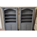 BOOKCASES, a pair, 122cm x 42cm x 199cm, Provincial style, grey painted, with cabinets to base. (2)