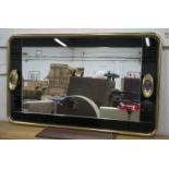 WALL MIRROR, 90cm H x 150cm W, circa 1970, brass with black glass border and twin lights.