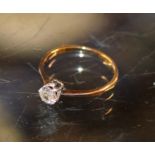 DIAMOND SOLITAIRE RING ON UNMARKED GOLD BAND, APPROXIMATELY .25 CARATS