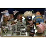 TRAY WITH VARIOUS HUMMEL FIGURINES, METAL ORNAMENTS, CHARACTER JUGS, SMALL CROWN DEVON TEAPOT ETC