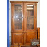 54½" REPRODUCTION MAHOGANY STAINED DOUBLE DOOR BOOKCASE WITH UNDER PRESS