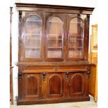 65" REPRODUCTION MAHOGANY STAINED TRIPLE DOOR BOOKCASE WITH PRESS BENEATH