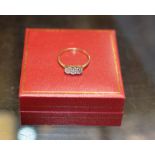 TRIPLE STONE DIAMOND RING ON GOLD BAND - APPROXIMATE WEIGHT = 2.1 GRAMS