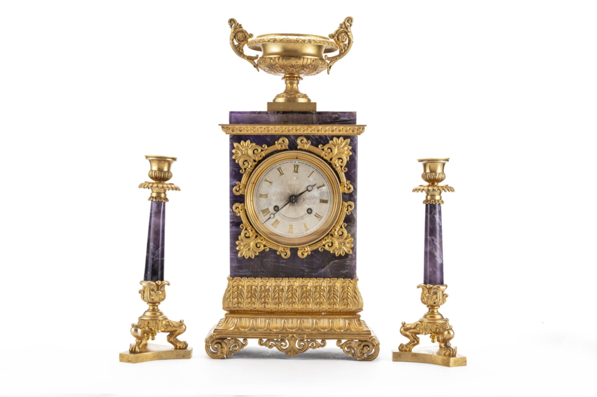 Trittico composto da orologio di appoggio e due candelabri in bronzo dorato e ametista