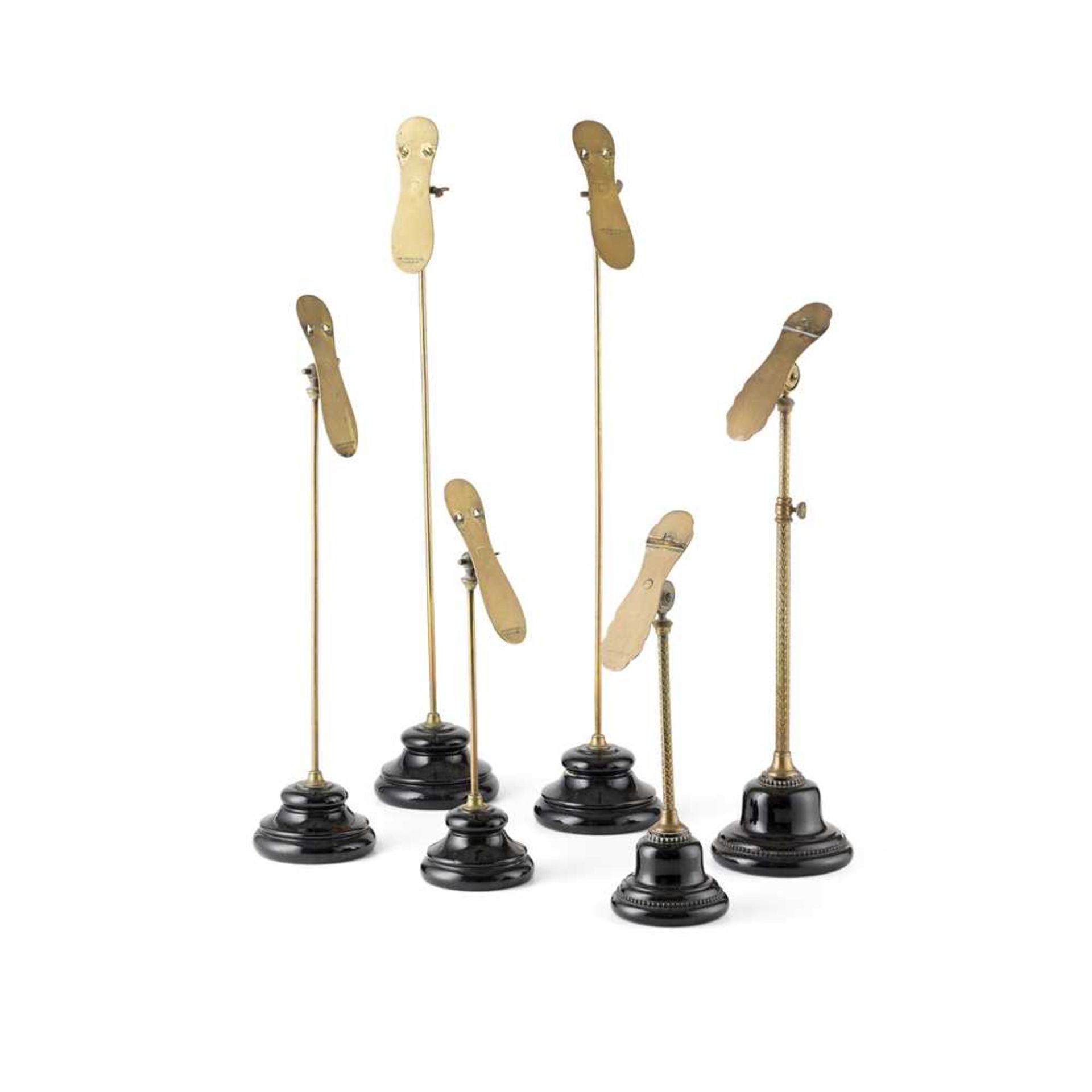 GROUP OF BRASS AND POTTERY SHOE DISPLAY STANDS LATE 19TH/ EARLY 20TH CENTURY