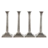 A set of four George III table candlesticks