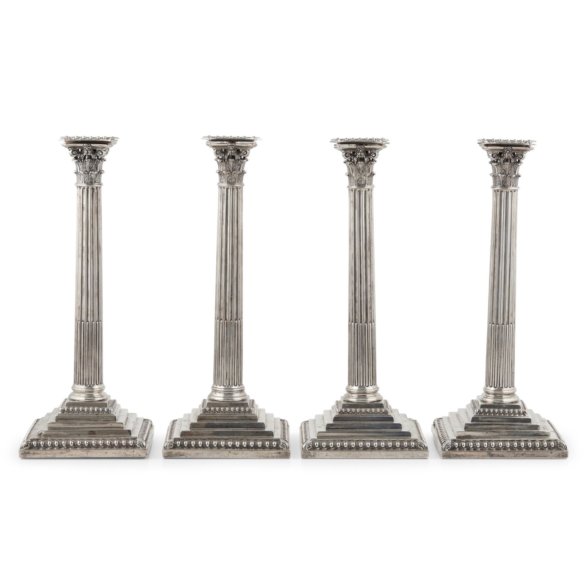 A set of four George III table candlesticks