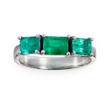 An emerald three-stone ring