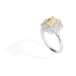 A yellow sapphire and diamond cluster ring