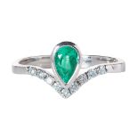 An emerald and diamond set ring