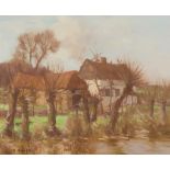 DAVID GAULD R.S.A (SCOTTISH 1865-1936) FARM BUILDINGS BY A RIVER, FRANCE