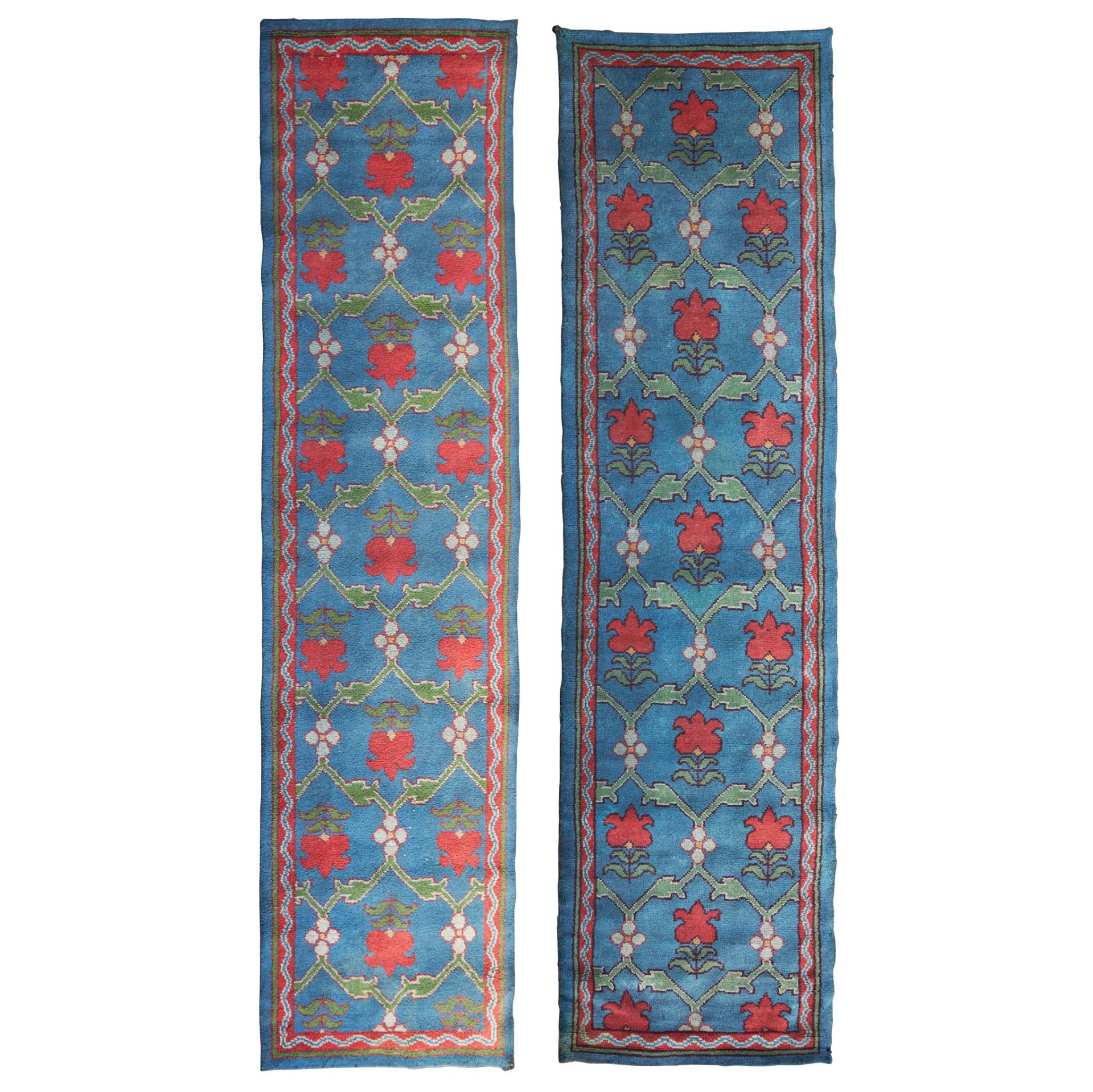 ATTRIBUTED TO ALEXANDER MORTON AND CO. PAIR OF ARTS & CRAFTS DONEGAL RUNNERS, CIRCA 1910