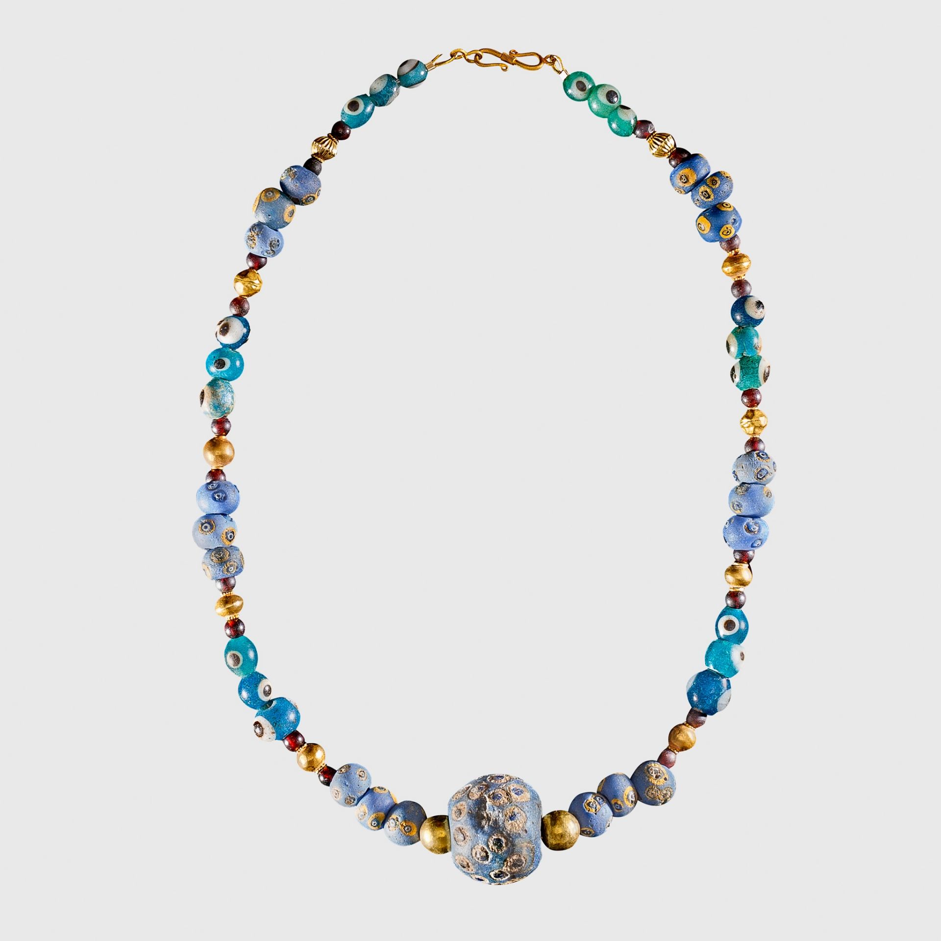 PHOENICIAN EYE GLASS AND GOLD BEAD NECKLACE NEAR EAST, C. 7TH CENTURY B.C.
