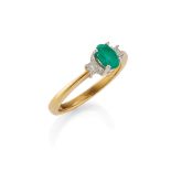 An emerald and diamond set three stone ring