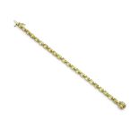 A peridot and diamond bracelet Composed of a continuous row of oval-cut peridot, to a similarly-