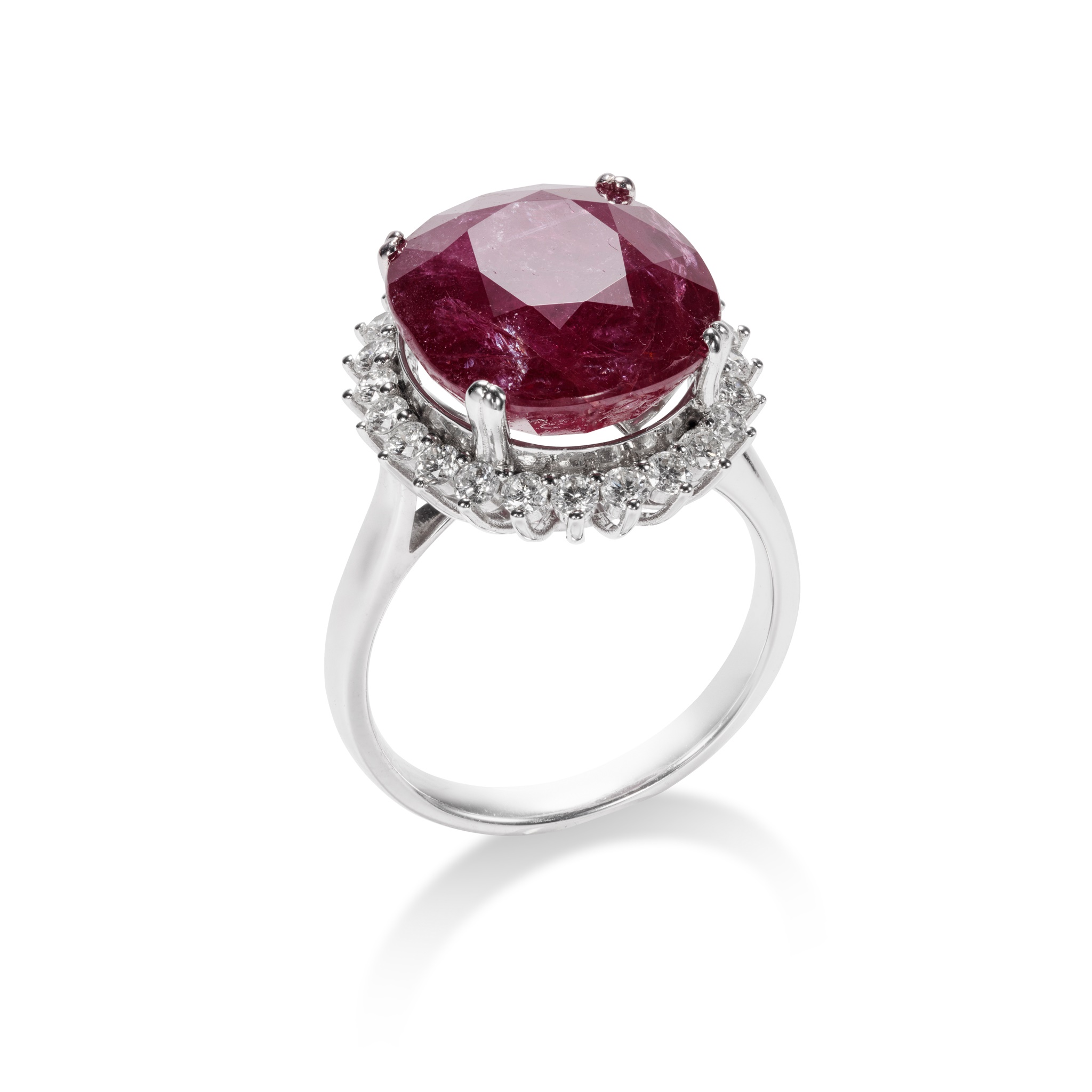 A ruby and diamond cluster ring The oval-cut ruby, weighing 11.87 carats, within a brilliant-cut - Image 2 of 2