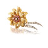 A ruby and diamond flower brooch Of bi-coloured design, the pierced flowerhead of brushed finish